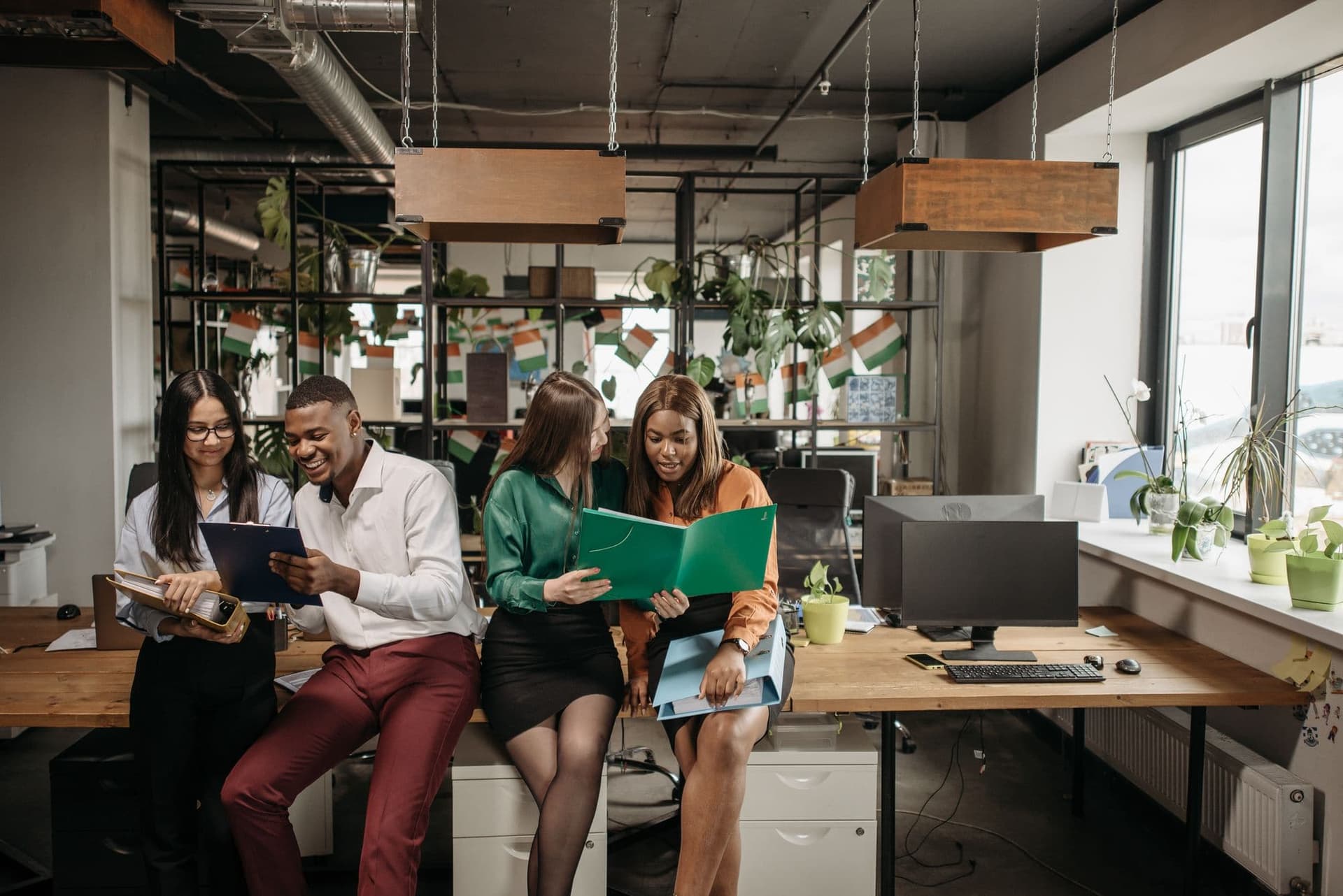 Colleagues sharing ideas in a bright open office